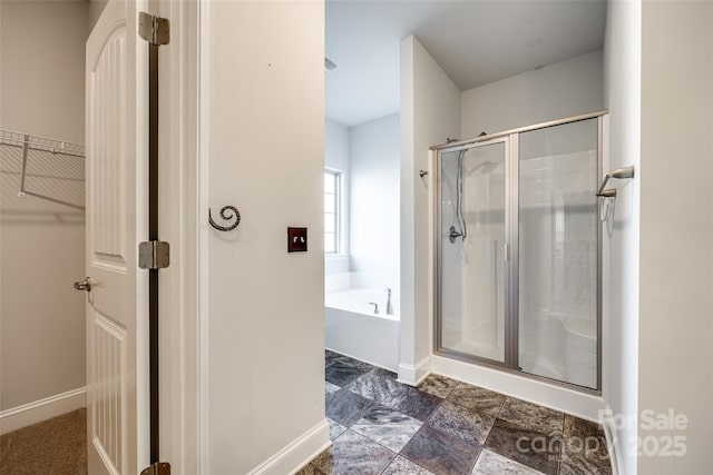 bathroom featuring independent shower and bath