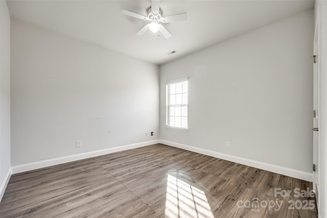 unfurnished room with ceiling fan and light wood-type flooring