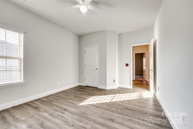 unfurnished bedroom with ceiling fan and light wood-type flooring