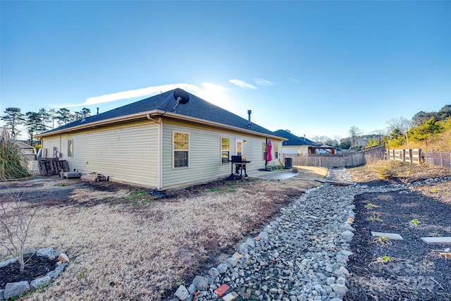 rear view of property with a patio and central air condition unit