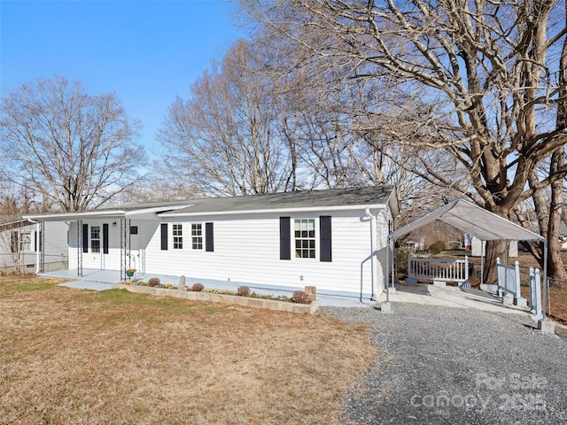 view of front facade with a carport and a front yard