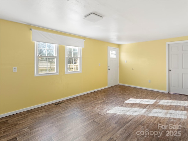 spare room with hardwood / wood-style floors