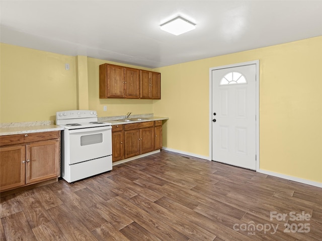 kitchen featuring dark wood-type flooring, sink, and electric stove