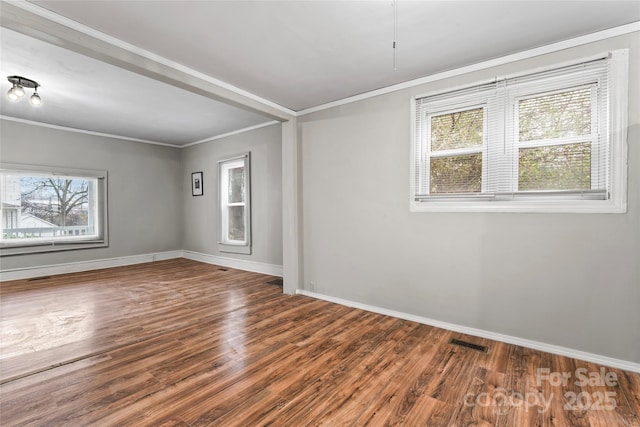 spare room with hardwood / wood-style floors and ornamental molding