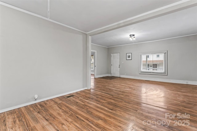 unfurnished room featuring hardwood / wood-style flooring and ornamental molding