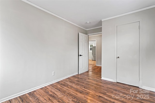 unfurnished bedroom featuring dark wood-type flooring and ornamental molding