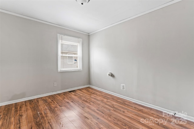 unfurnished room with hardwood / wood-style floors and crown molding