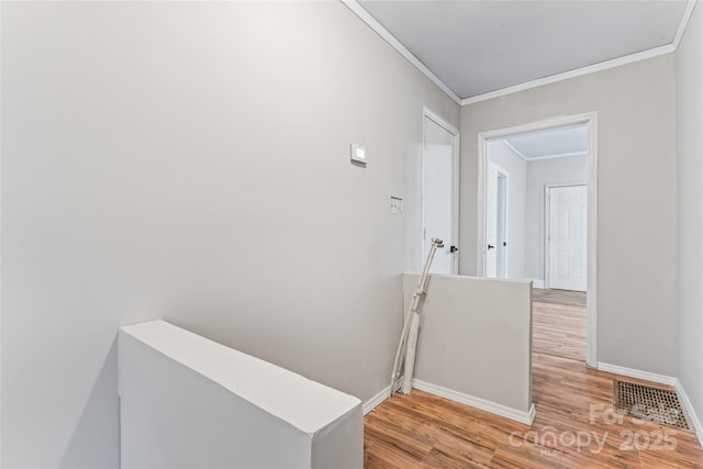 corridor featuring hardwood / wood-style floors and ornamental molding