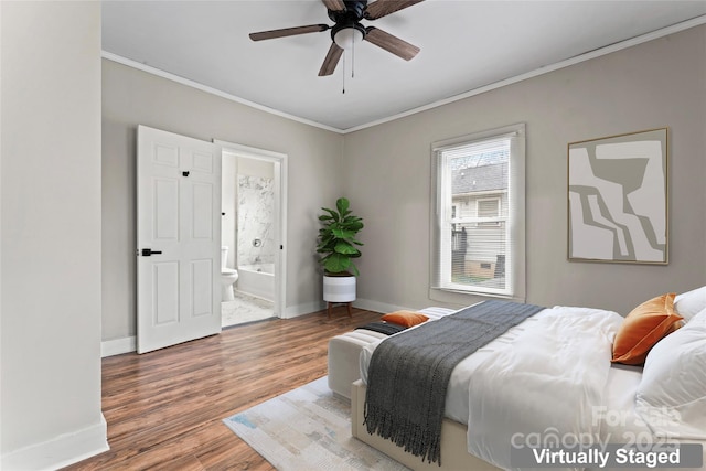 bedroom with hardwood / wood-style flooring, ceiling fan, ornamental molding, and ensuite bath