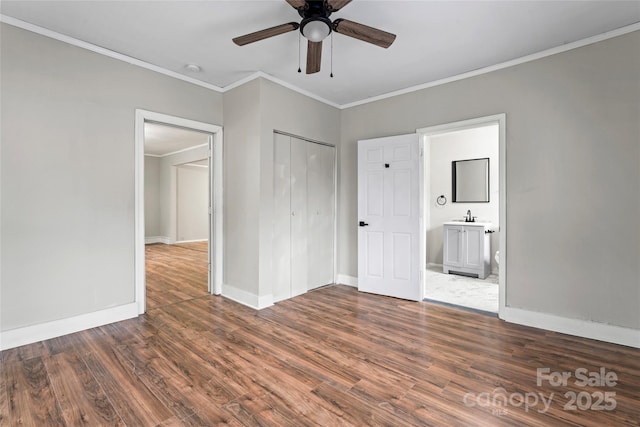 unfurnished bedroom featuring a closet, ceiling fan, crown molding, and dark wood-type flooring