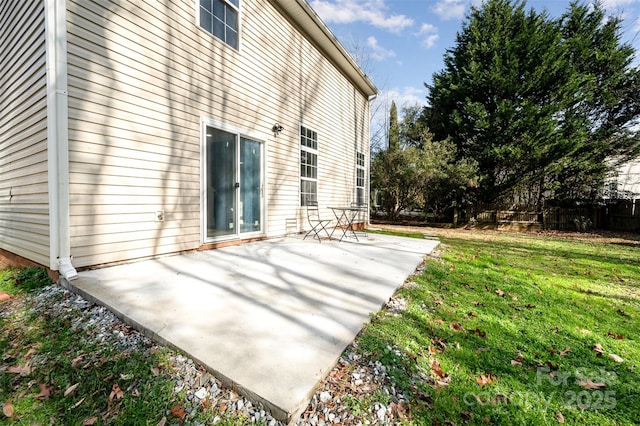 back of house with a yard and a patio