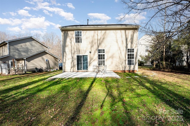 back of house with a yard and a patio