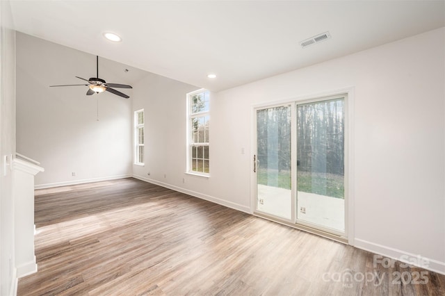 unfurnished living room with vaulted ceiling, ceiling fan, and light hardwood / wood-style flooring