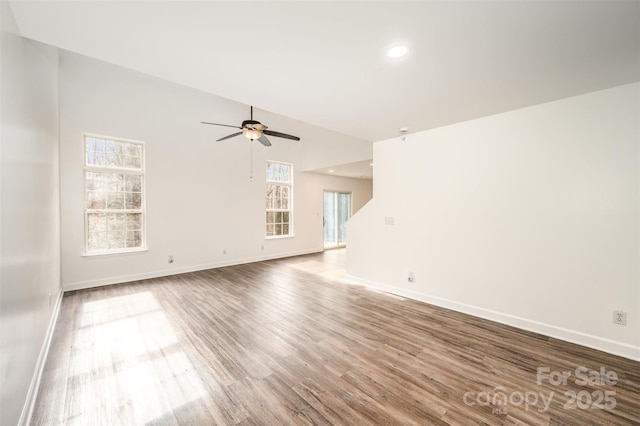 unfurnished living room with ceiling fan and wood-type flooring