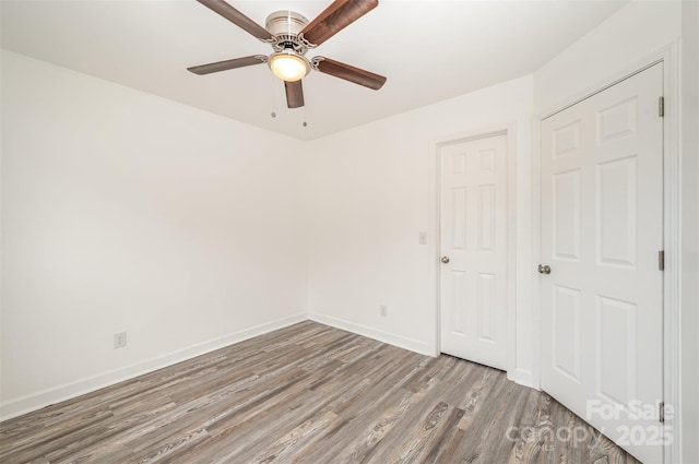 unfurnished bedroom with ceiling fan and light hardwood / wood-style flooring