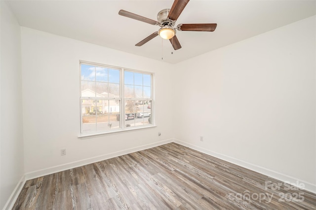 empty room with ceiling fan and hardwood / wood-style flooring