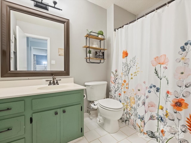 bathroom with a textured ceiling, toilet, tile patterned floors, and vanity