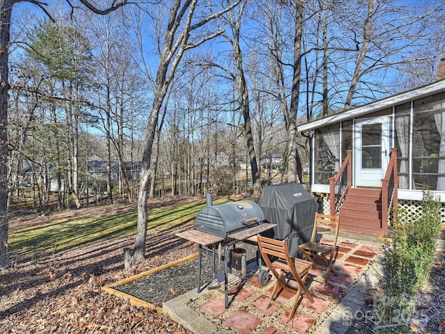 view of yard featuring a sunroom and a patio