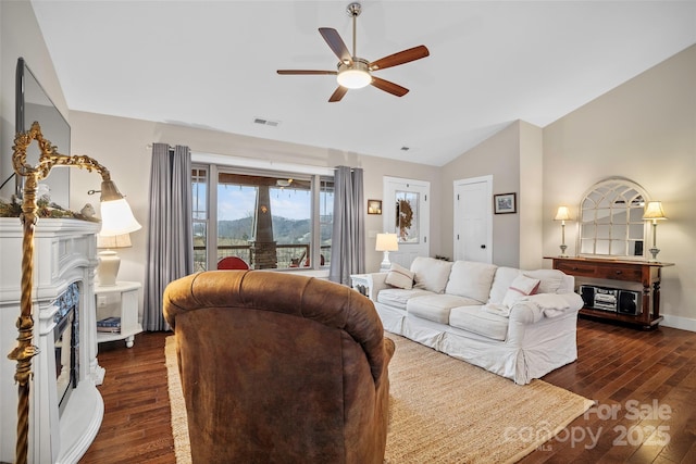 living room featuring lofted ceiling, dark hardwood / wood-style flooring, and ceiling fan