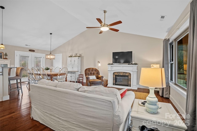 living room featuring ceiling fan, lofted ceiling, and dark hardwood / wood-style flooring