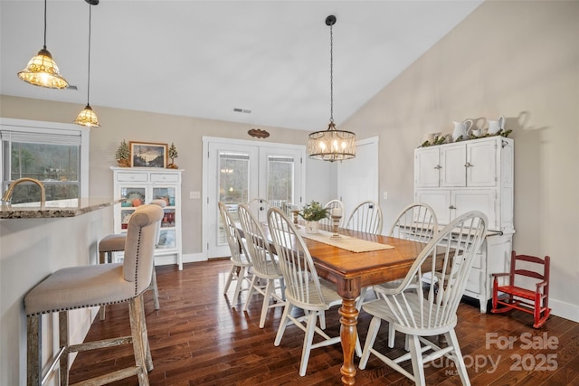 dining room with dark hardwood / wood-style flooring, sink, high vaulted ceiling, and french doors