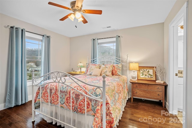 bedroom with dark wood-type flooring and ceiling fan