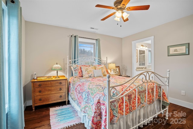 bedroom with dark hardwood / wood-style flooring, ceiling fan, and ensuite bathroom