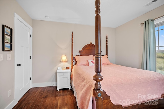 bedroom with dark hardwood / wood-style floors