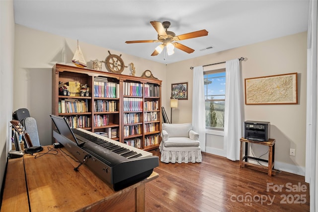 sitting room featuring ceiling fan and wood-type flooring