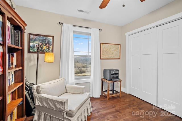 sitting room with ceiling fan and dark hardwood / wood-style floors