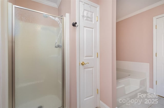 bathroom with tile patterned flooring, crown molding, and shower with separate bathtub