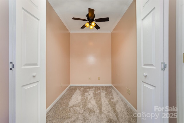 spare room with crown molding, ceiling fan, and carpet