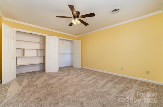 unfurnished bedroom with ornamental molding, carpet floors, and ceiling fan