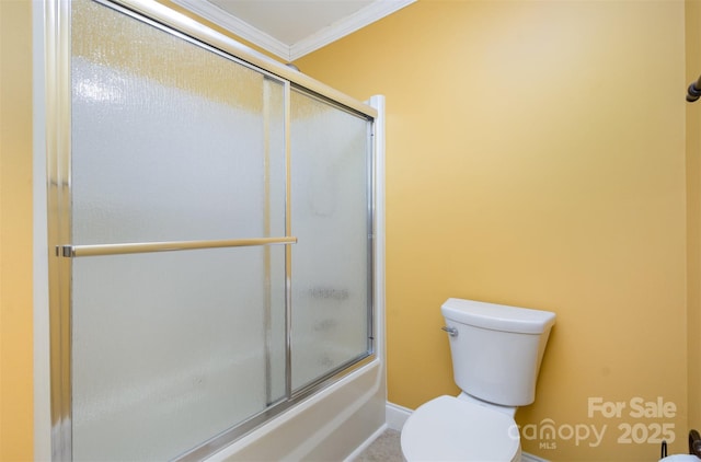 bathroom with bath / shower combo with glass door, ornamental molding, and toilet