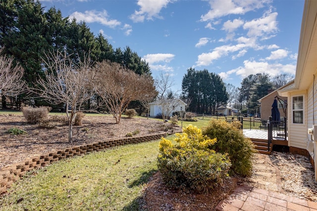 view of yard featuring a shed and a wooden deck