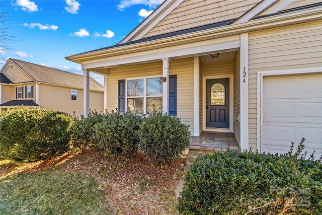 doorway to property with a garage