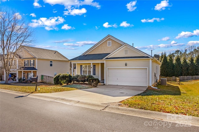 view of front of house featuring a garage, a front yard, and central air condition unit