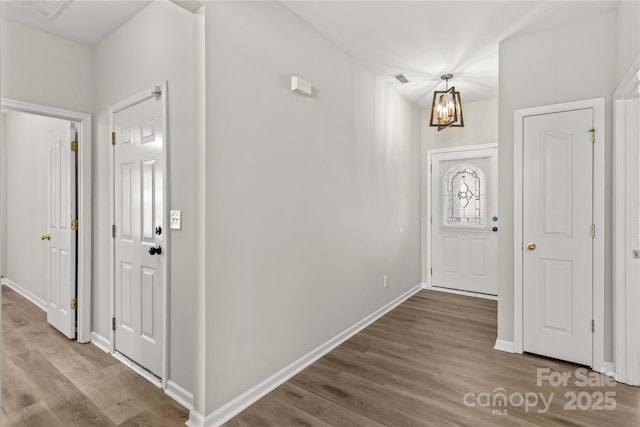 entrance foyer featuring hardwood / wood-style flooring and an inviting chandelier