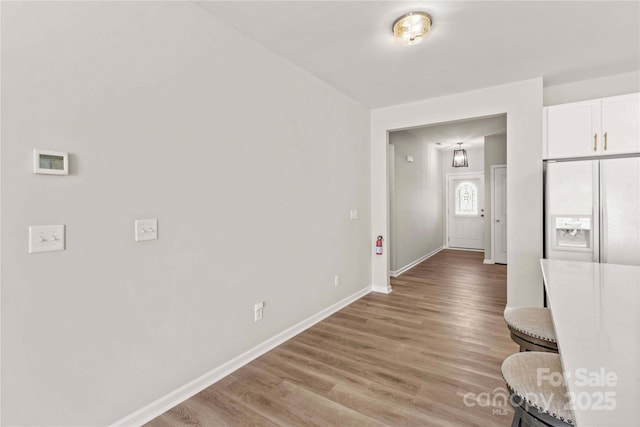 hallway with light hardwood / wood-style floors