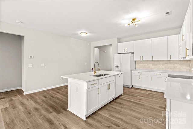 kitchen featuring white cabinetry, white appliances, and sink