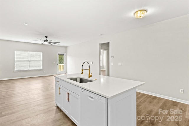 kitchen featuring white cabinetry, sink, white dishwasher, a center island with sink, and light hardwood / wood-style flooring