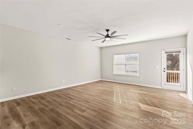 empty room with wood-type flooring and ceiling fan