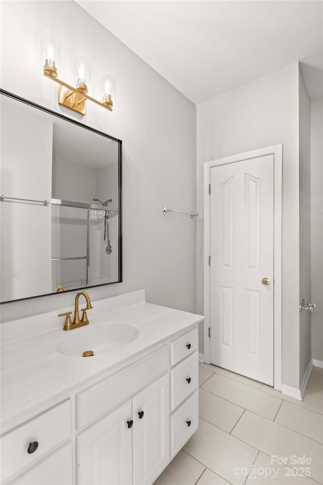 bathroom with walk in shower, tile patterned floors, and vanity