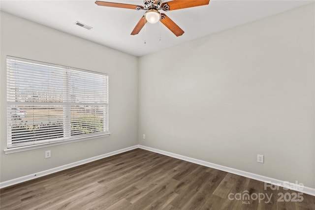 unfurnished room featuring dark hardwood / wood-style floors and ceiling fan