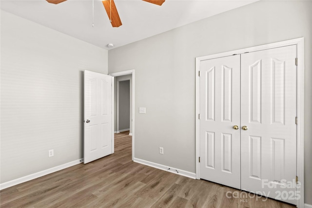 unfurnished bedroom with light hardwood / wood-style flooring, a closet, and ceiling fan