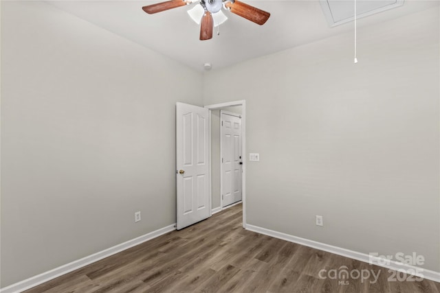 unfurnished room featuring dark hardwood / wood-style floors and ceiling fan