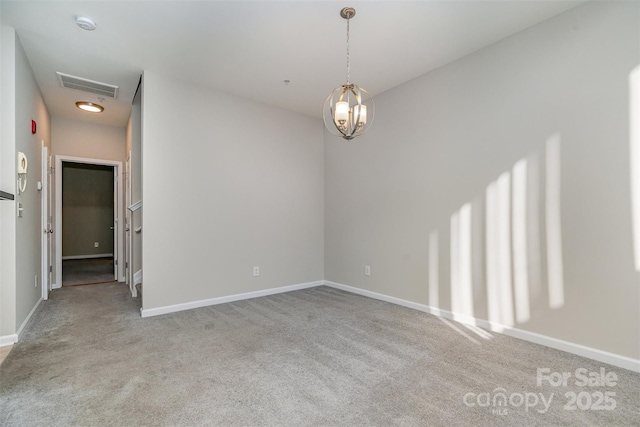 spare room featuring light colored carpet and a notable chandelier