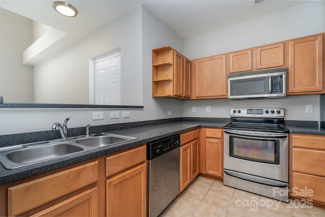 kitchen featuring light tile patterned floors, appliances with stainless steel finishes, and sink