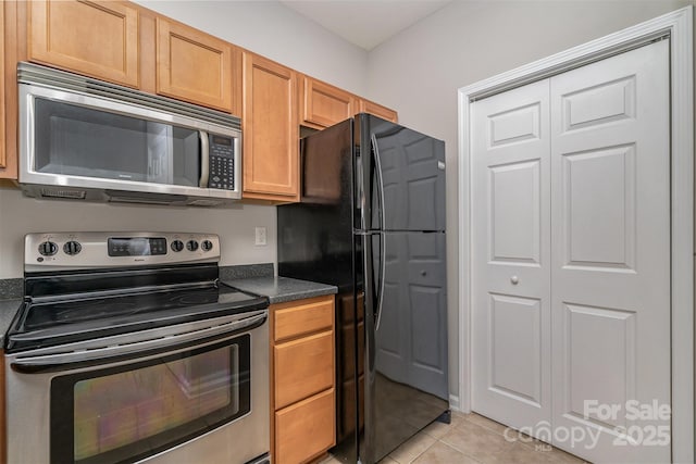 kitchen with light tile patterned floors and appliances with stainless steel finishes