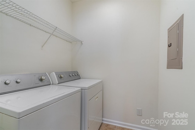 washroom with light tile patterned floors, separate washer and dryer, and electric panel